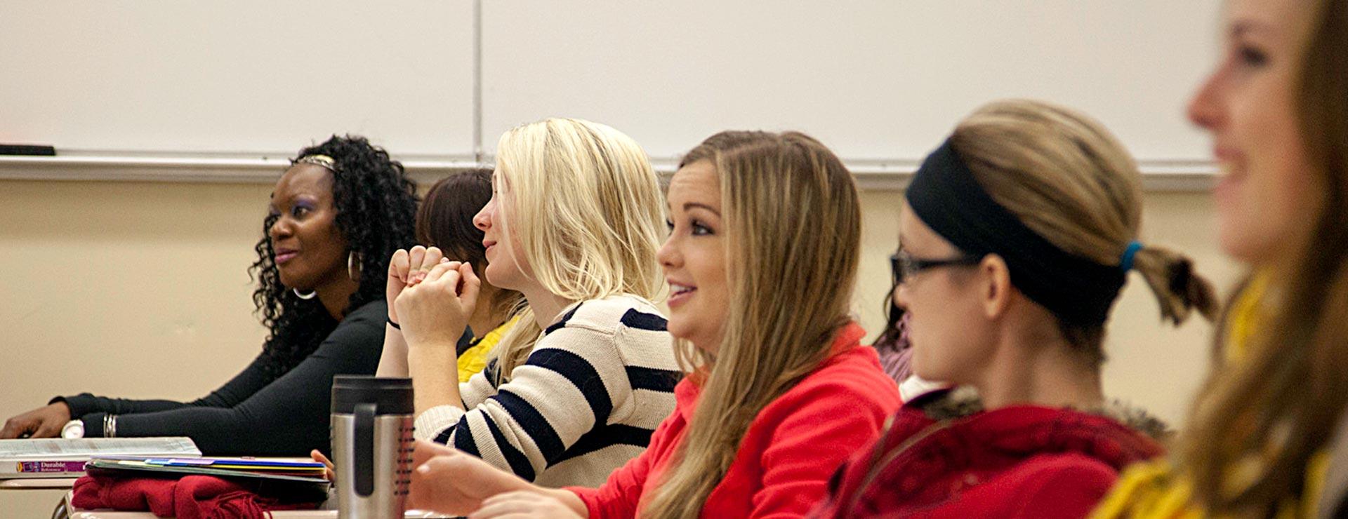 Female students participating in classroom discussion