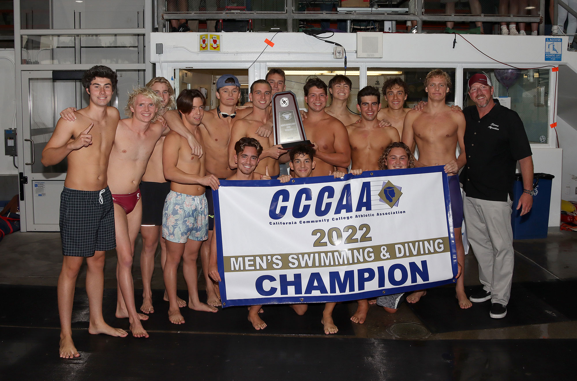 Sierra College Men's Swimming and Diving Team Holds Up 2022 California State Champions sign and trophy