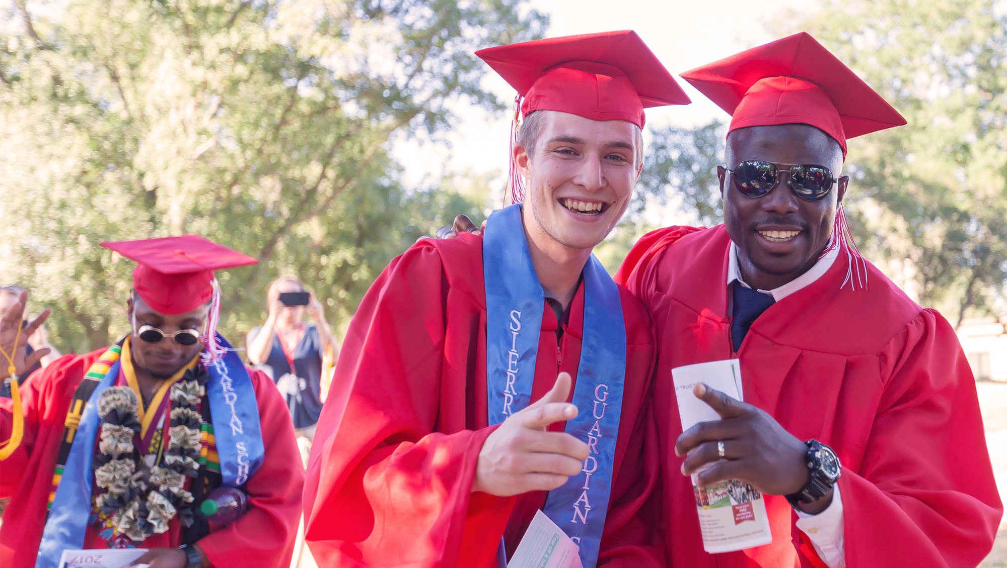 Proud graduates wearing Guardian Scholar stoles and celebrating at Sierra College graduation
