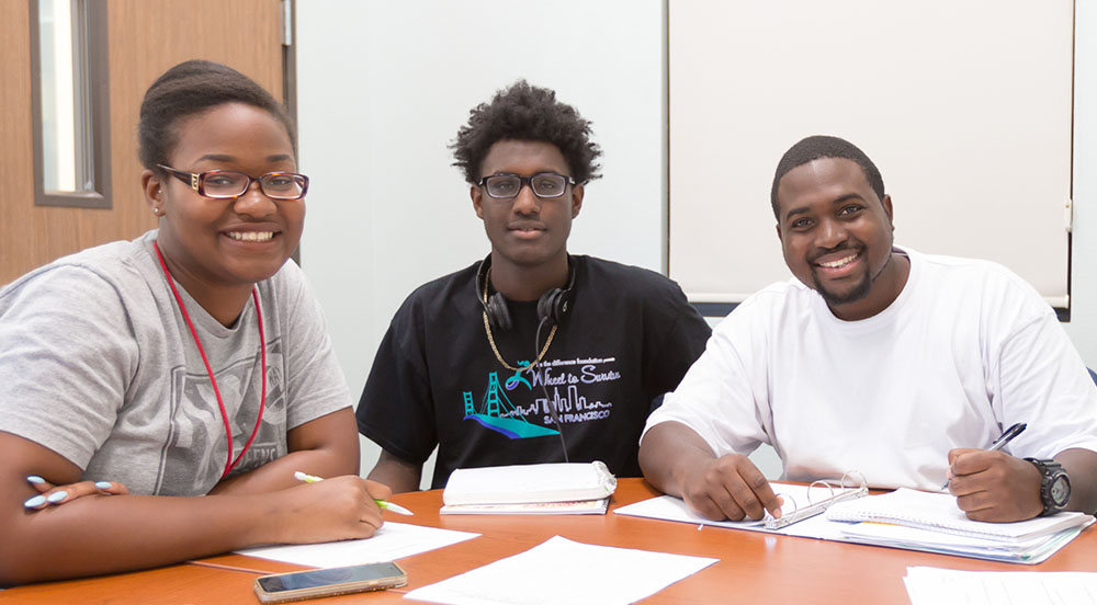 Three black students studying at the Cross Cultural Center