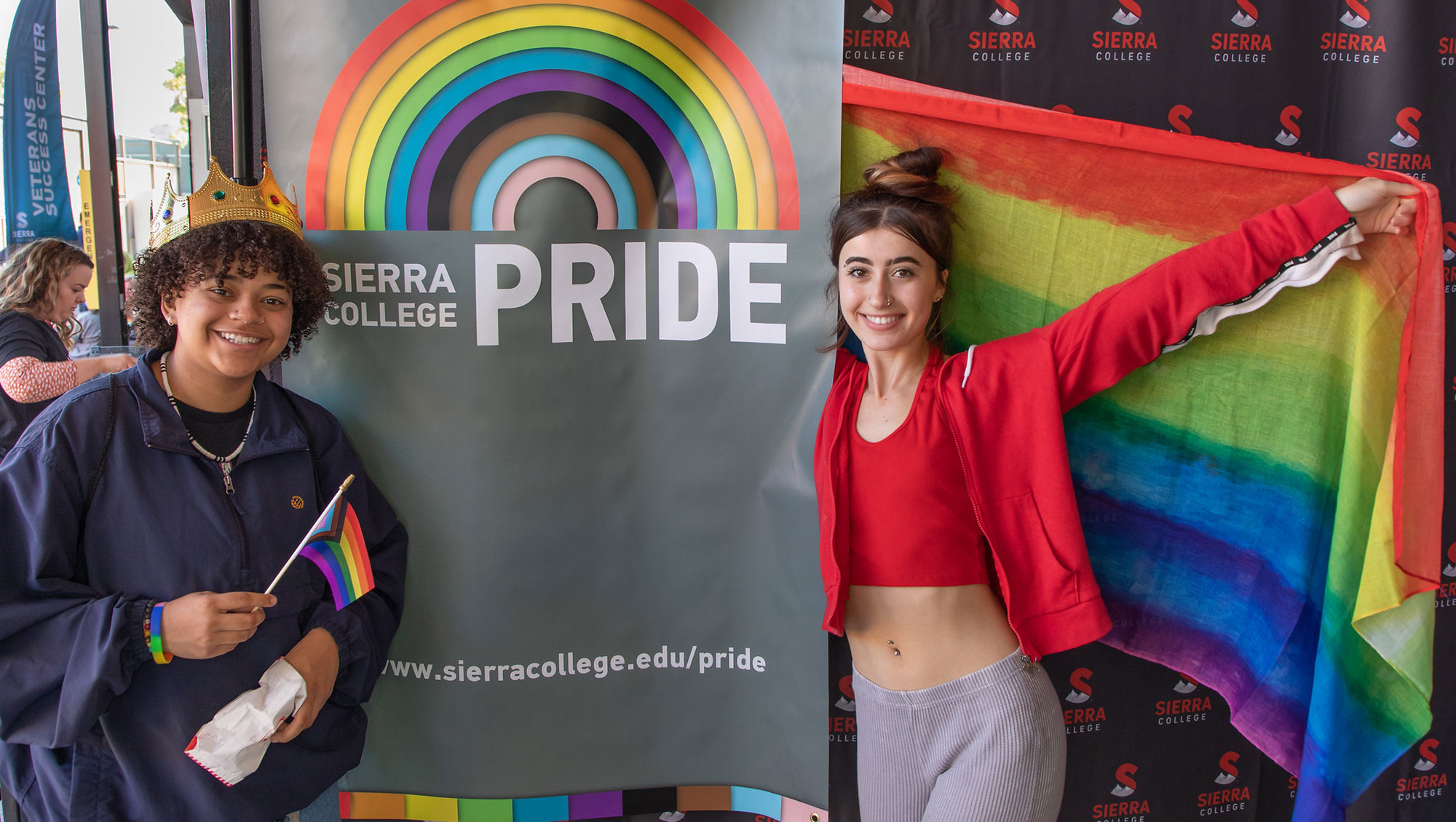 Two students in front of Sierra College Pride sign on Rocklin Campus